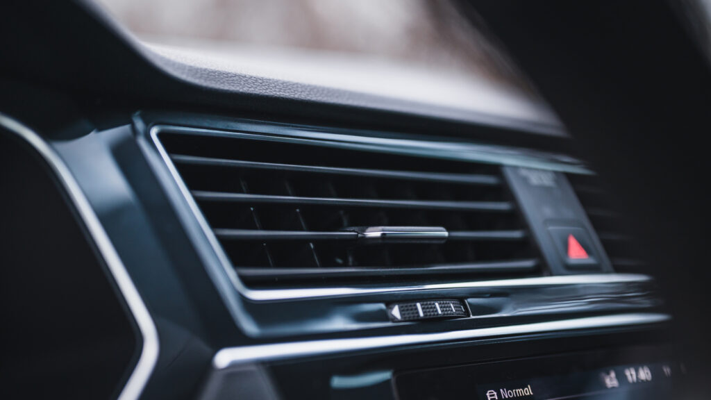 closeup of a black air conditioning vent in a car