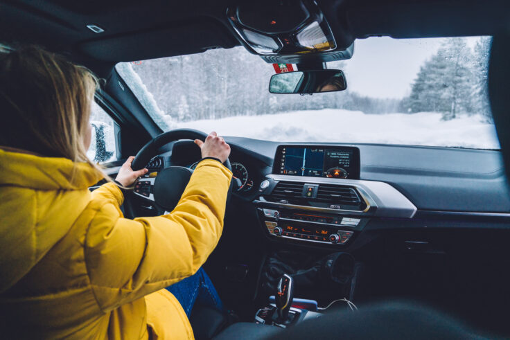 Professional female driver exploring Michigan by car in the winter